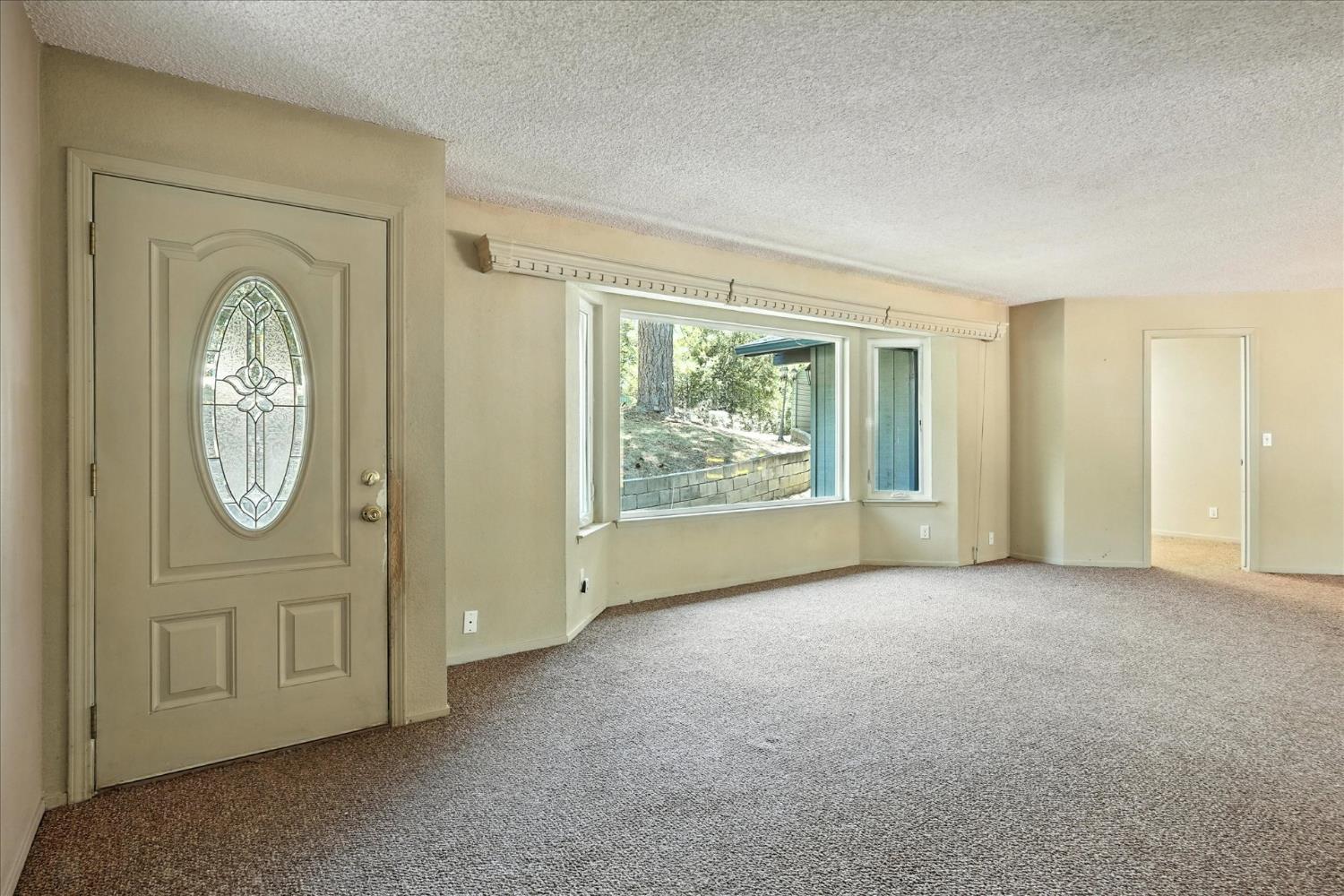 5783 Chowchilla Mountain Road Mariposa, CA 95338 - Photo 6 of 43 an empty room with entrance and windows