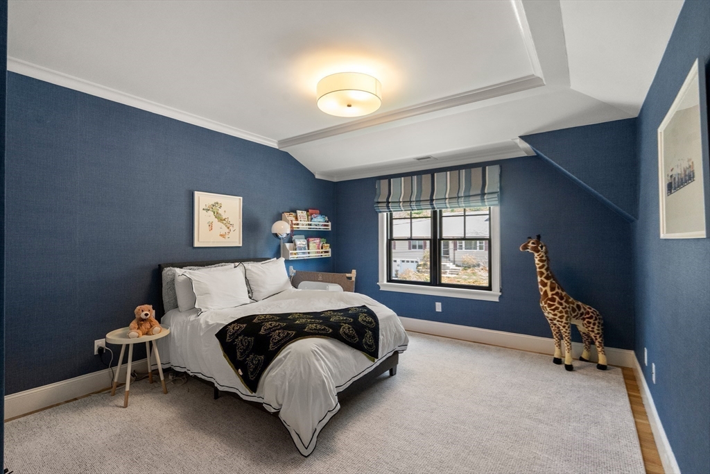 7 Massasoit Road Wellesley, MA 02481 - Photo 27 of 42 a spacious bedroom with a bed and a window