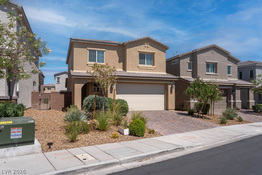 7126 Calvert Cliffs Street North Las Vegas, NV 89084 - Photo 41 of 44 A classic two-story residence boasts a paved driveway, integrated garage, and well-maintained xeriscaped front yard.