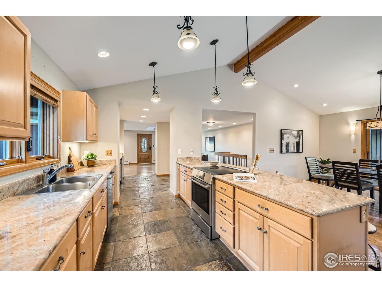 5604 Bowron Place Longmont, CO 80503 - Photo 11 of 37 a kitchen with a stove a sink a center island and furniture