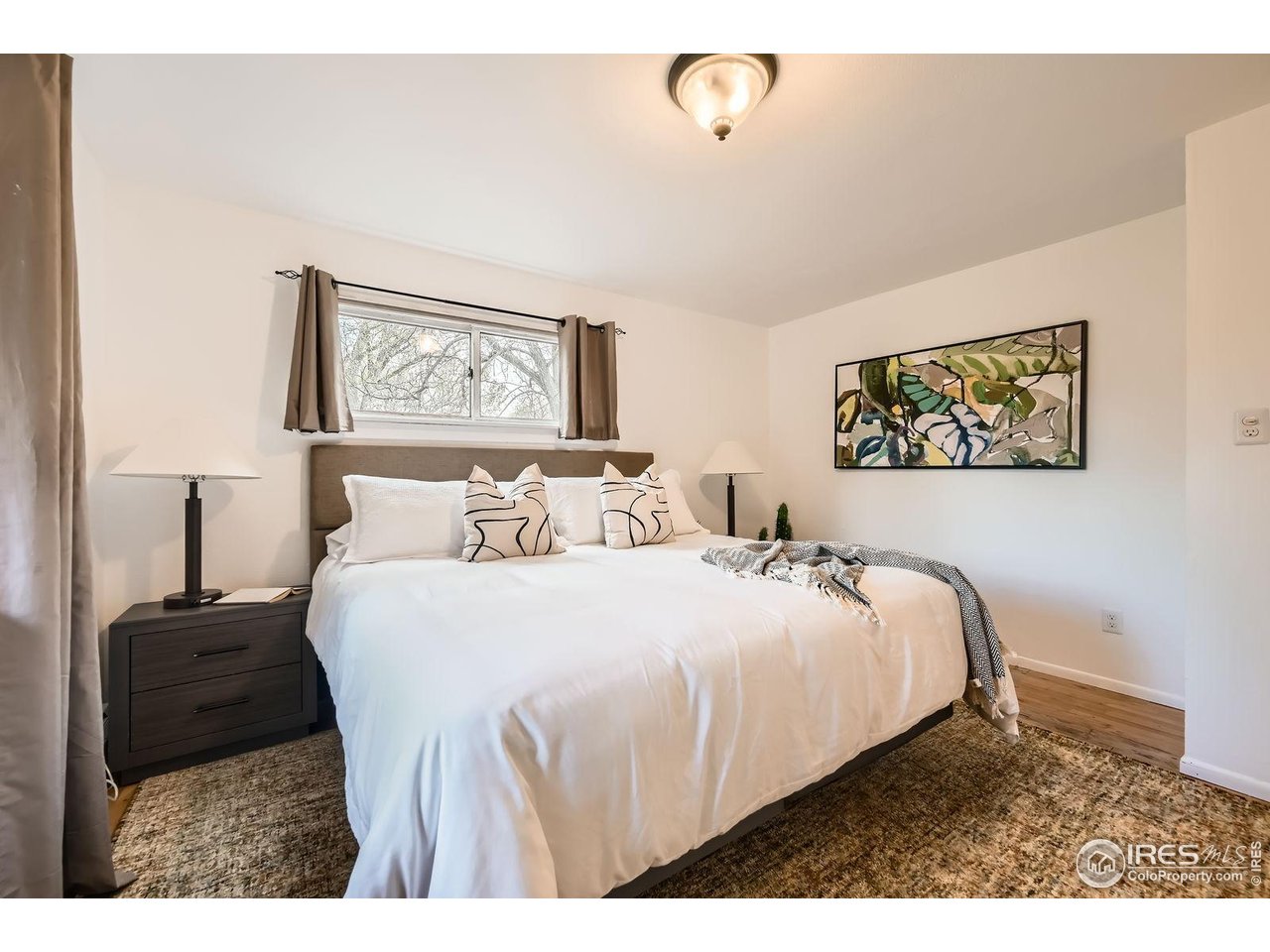5604 Bowron Place Longmont, CO 80503 - Photo 14 of 37 a bedroom with a bed and a painting on the wall