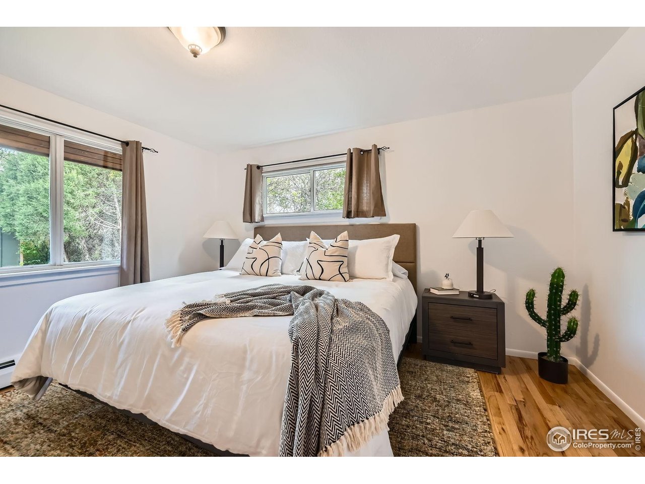 5604 Bowron Place Longmont, CO 80503 - Photo 15 of 37 a bedroom with a bed and a painting on the wall