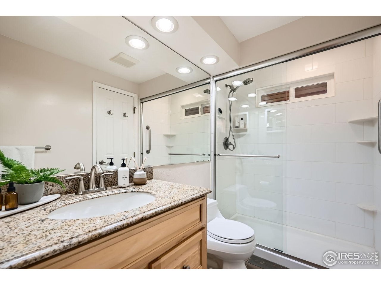 5604 Bowron Place Longmont, CO 80503 - Photo 16 of 37 a bathroom with a granite countertop sink toilet and shower