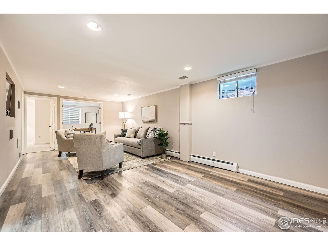 5604 Bowron Place Longmont, CO 80503 - Photo 23 of 37 a living room with furniture and a table