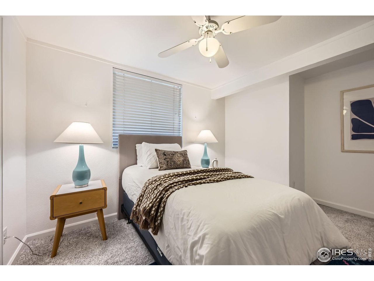 5604 Bowron Place Longmont, CO 80503 - Photo 24 of 37 a bedroom with a bed and a lamp