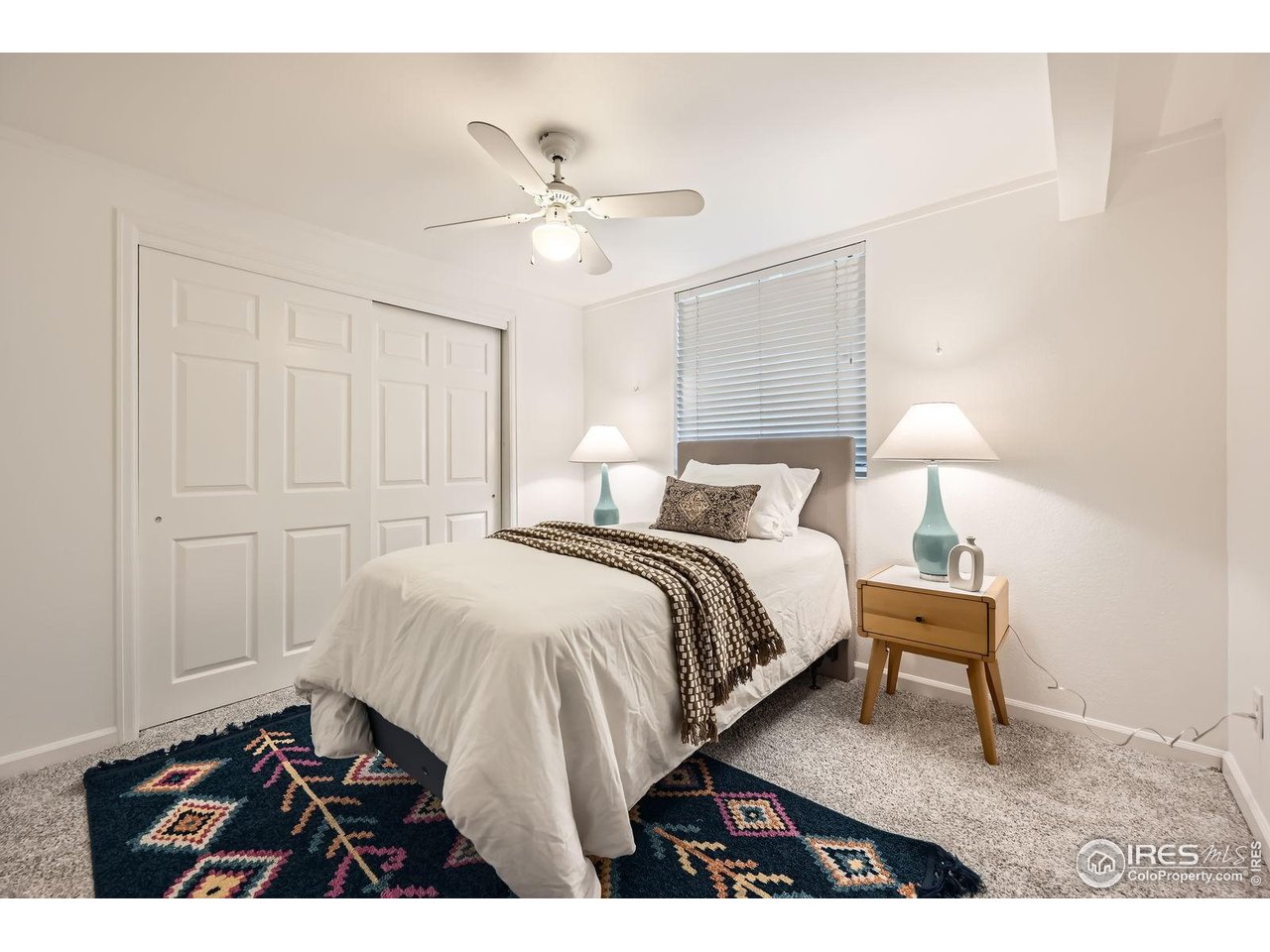 5604 Bowron Place Longmont, CO 80503 - Photo 25 of 37 a bedroom with a bed and a lamp