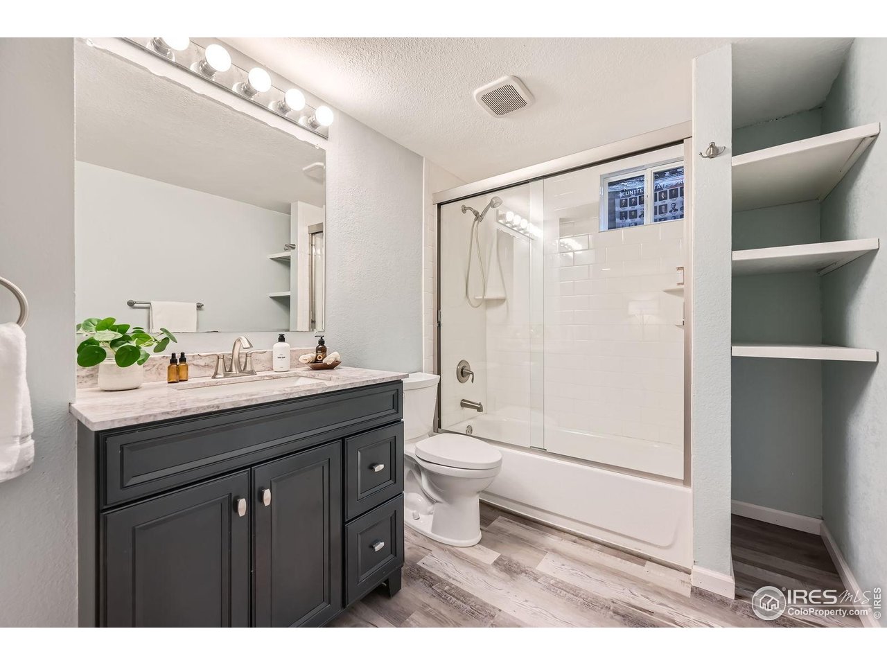 5604 Bowron Place Longmont, CO 80503 - Photo 26 of 37 a bathroom with a double vanity sink toilet and shower