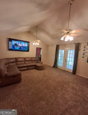 a view of a livingroom with furniture and a ceiling fan