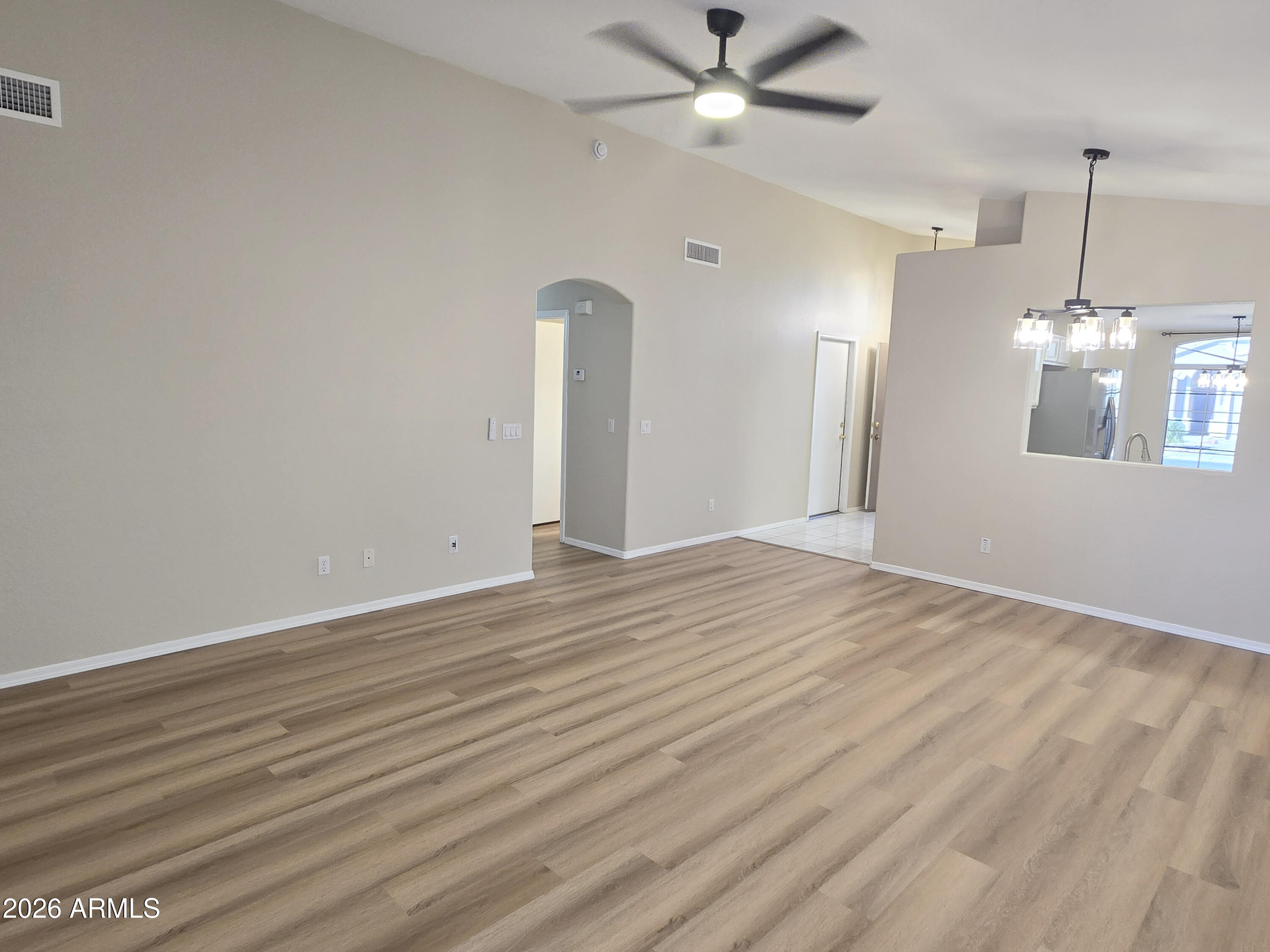 697 West Golden Street Gilbert, AZ 85233 - Photo 14 of 33 an empty room with wooden floor fan and windows