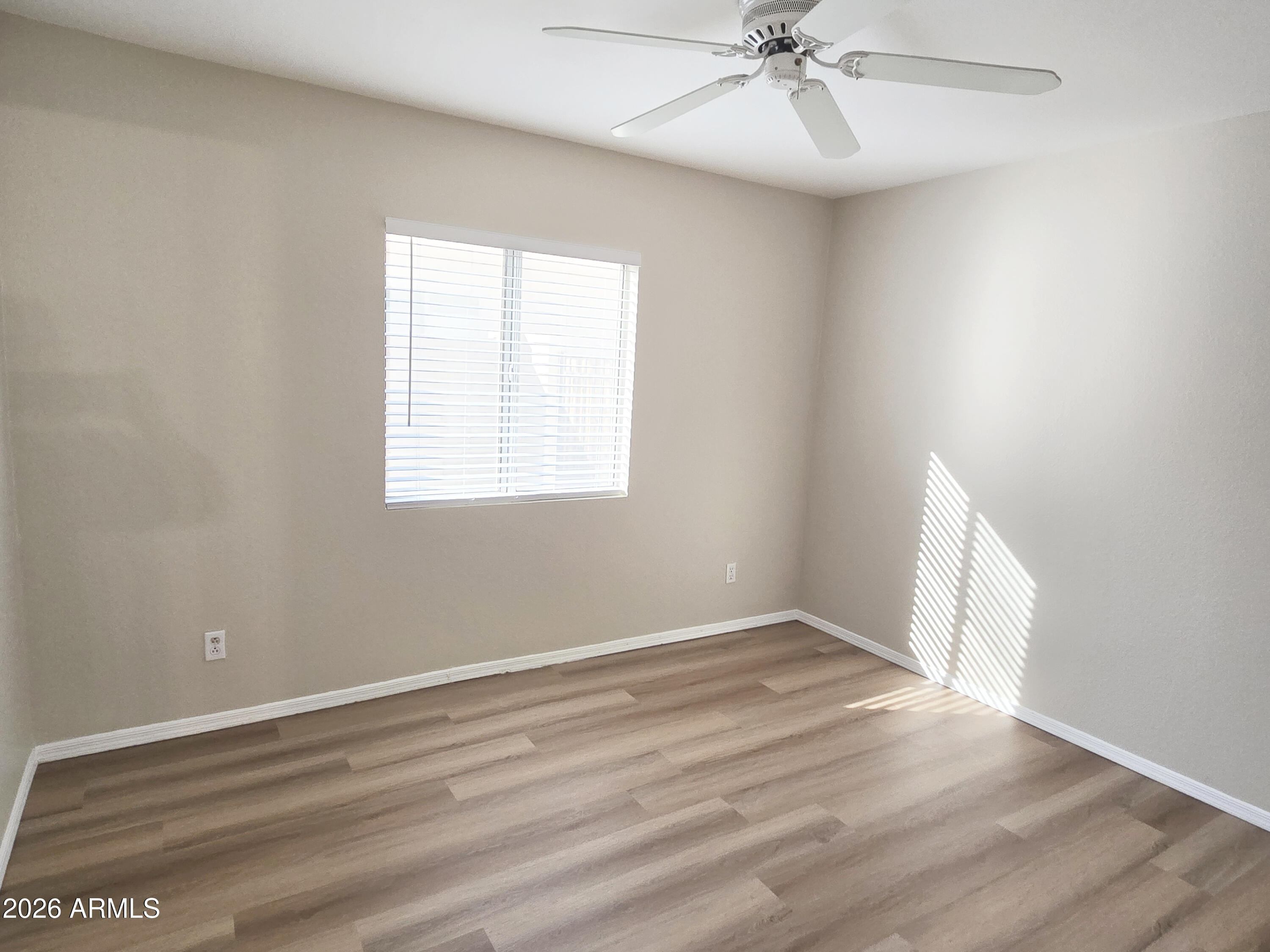 697 West Golden Street Gilbert, AZ 85233 - Photo 19 of 33 an empty room with a window and a fan
