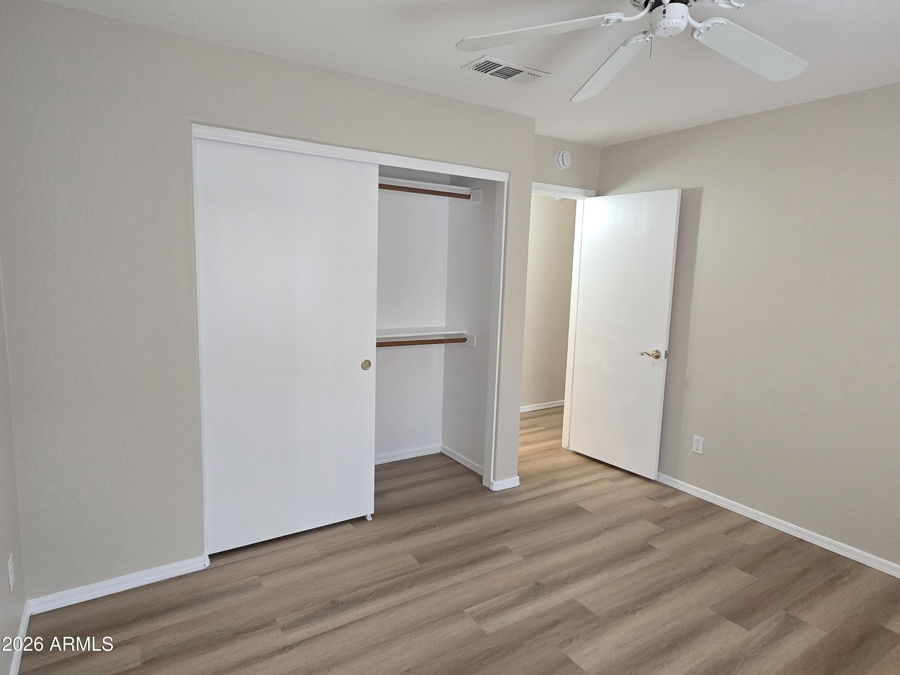697 West Golden Street Gilbert, AZ 85233 - Photo 20 of 33 an empty room with wooden floor and a ceiling fan