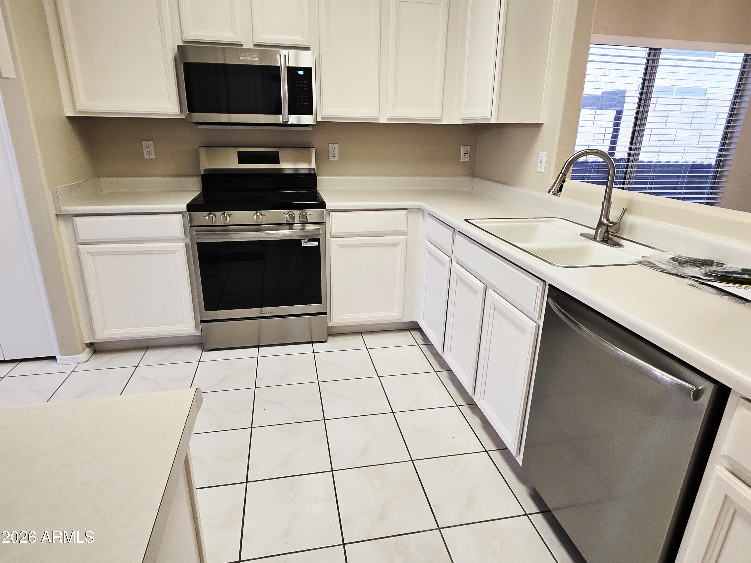 697 West Golden Street Gilbert, AZ 85233 - Photo 5 of 33 a kitchen with a sink and a stove top oven