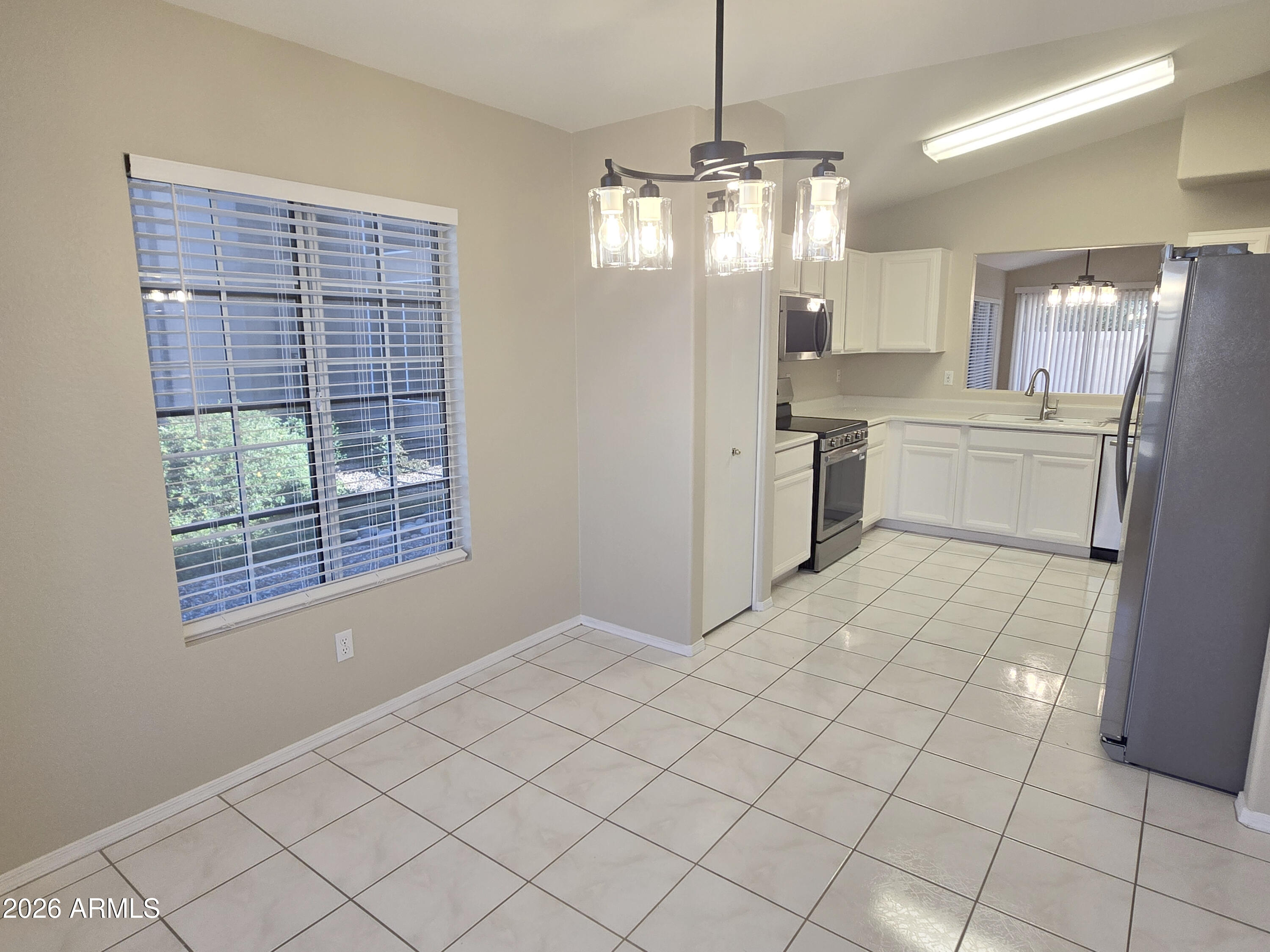 697 West Golden Street Gilbert, AZ 85233 - Photo 9 of 33 a large white kitchen with a sink stainless steel appliances and cabinets