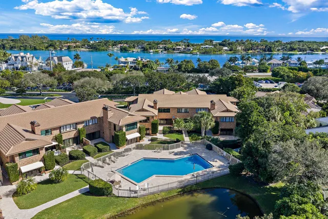 an aerial view of a house with swimming pool outdoor seating and yard