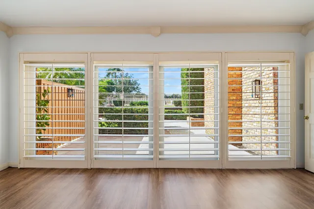 a view of wooden floor and windows in a room
