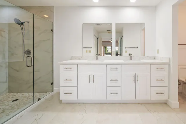 a bathroom with a shower sink and mirror