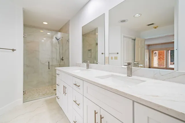a bathroom with a granite countertop sink mirror and double