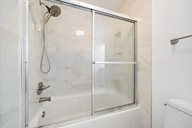 a bathroom with a glass shower door