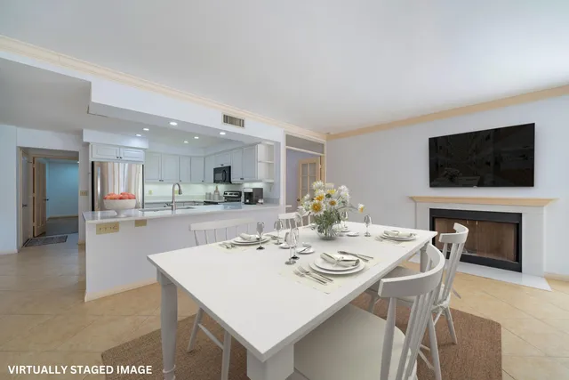 a view of a dining room kitchen and a kitchen with a table chairs