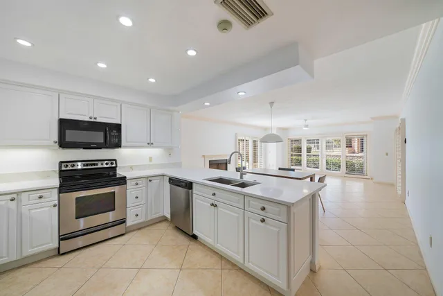 a kitchen with a sink stove and cabinets