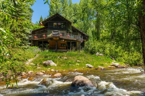 a backyard of a house with yard and outdoor seating