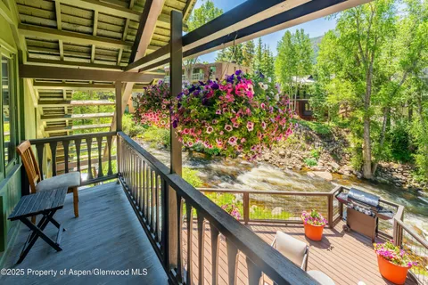 a view of a balcony with wooden chairs