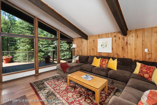 a living room with furniture and a floor to ceiling window