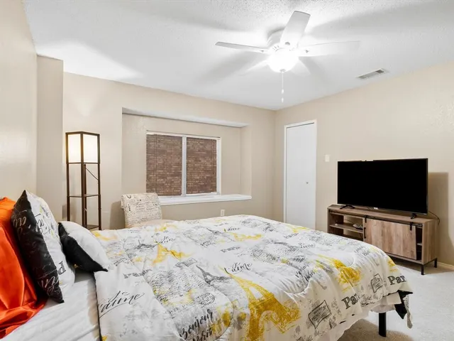 a bedroom with a bed and a chair