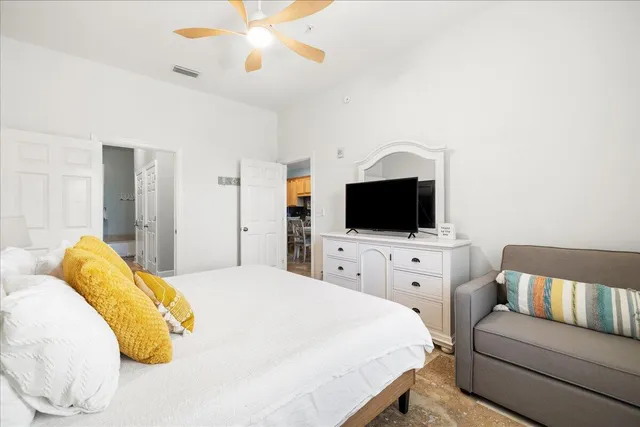 a bedroom with a bed and a flat screen tv