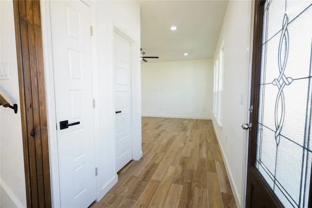a view of a bathroom with a sink and wooden floor