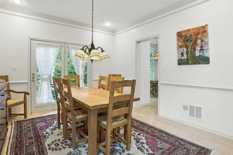 a view of a dining room with furniture wooden floor and a chandelier