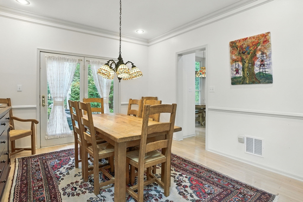 7 Alder Way, Unit 7 Bedford, MA 01730 - Photo 11 of 30 a view of a dining room with furniture wooden floor and a chandelier