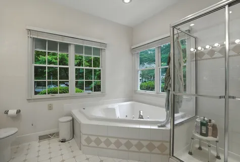 a white bath tub sitting next to a toilet