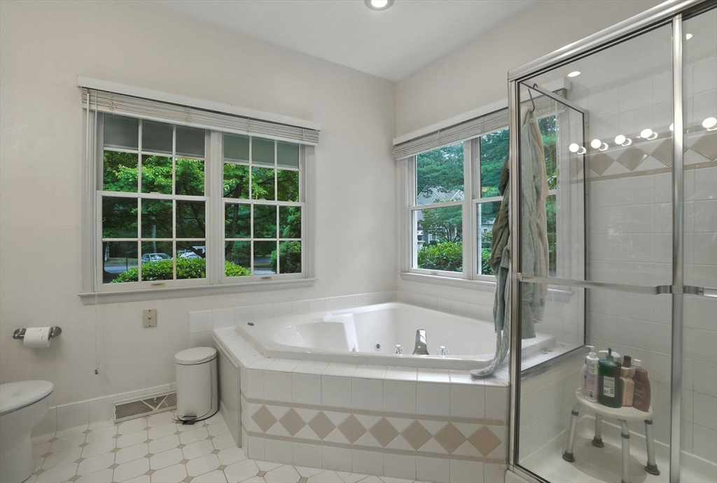 7 Alder Way, Unit 7 Bedford, MA 01730 - Photo 14 of 30 a white bath tub sitting next to a toilet