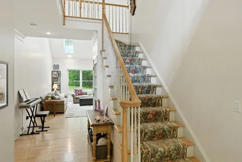 a living room with furniture and floor to ceiling windows
