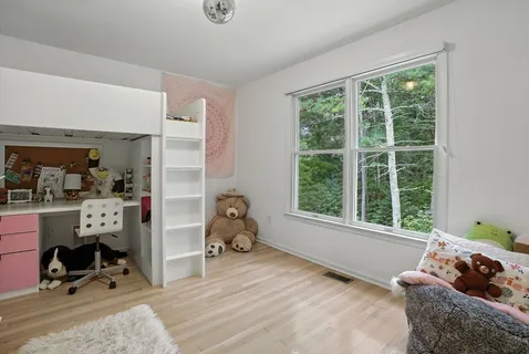 a bedroom with furniture and a window