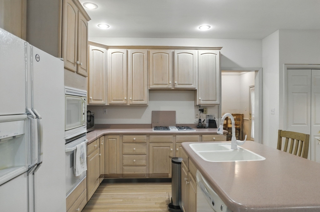 7 Alder Way, Unit 7 Bedford, MA 01730 - Photo 5 of 30 a kitchen with a sink a stove a refrigerator and cabinets