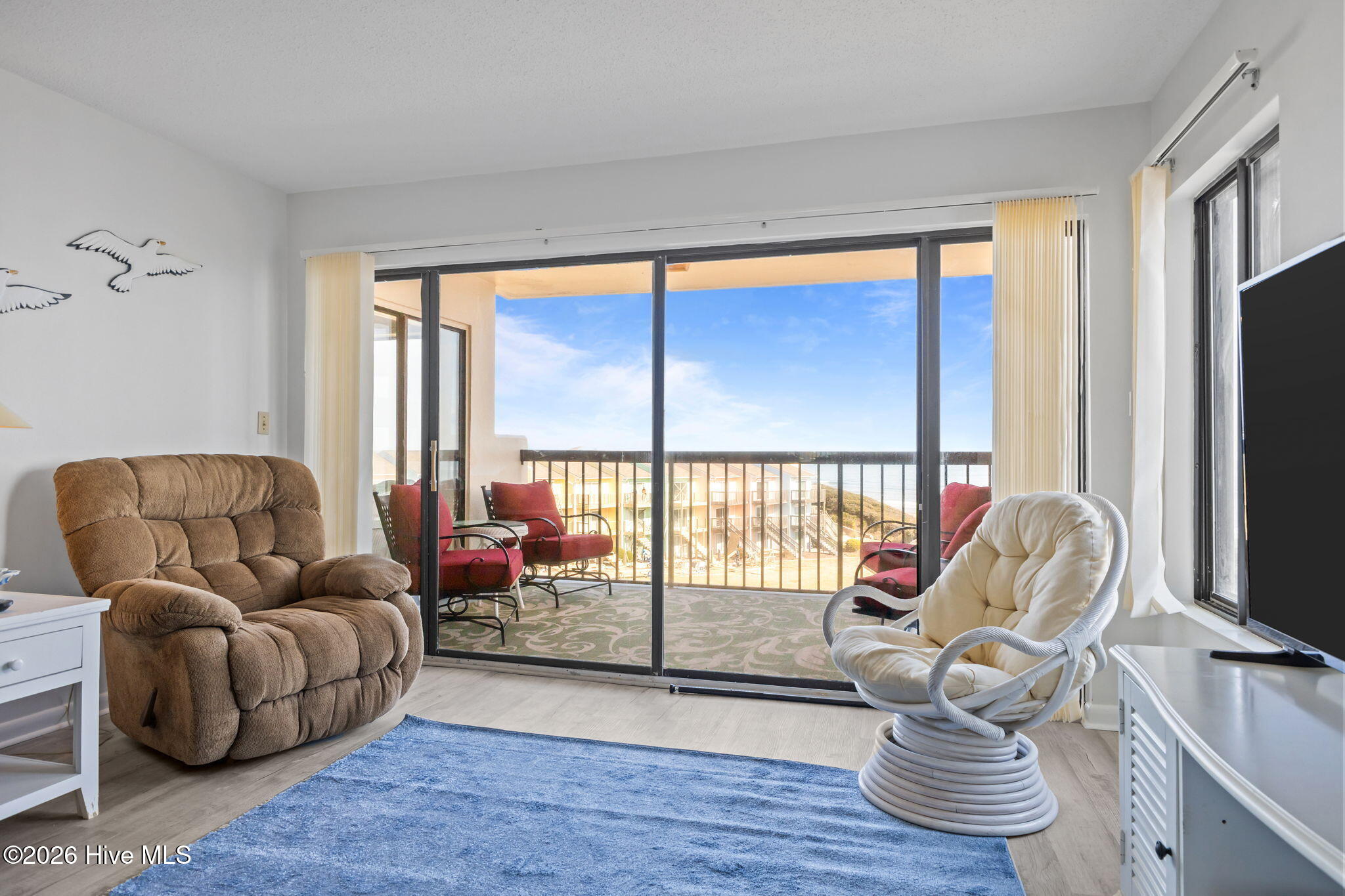 8801 Reed Drive, Unit 314W Emerald Isle, NC 28594 - Photo 7 of 53 Living Area Opens to Covered Balcony