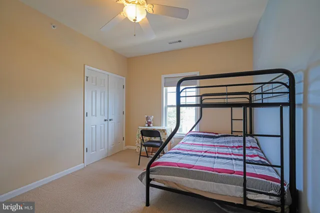 a bedroom with bunk bed and a window