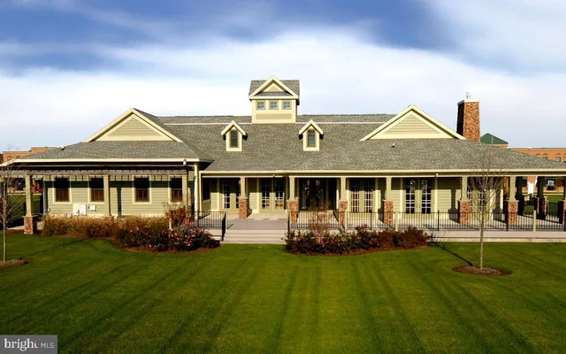 a front view of a house with a yard table and chairs