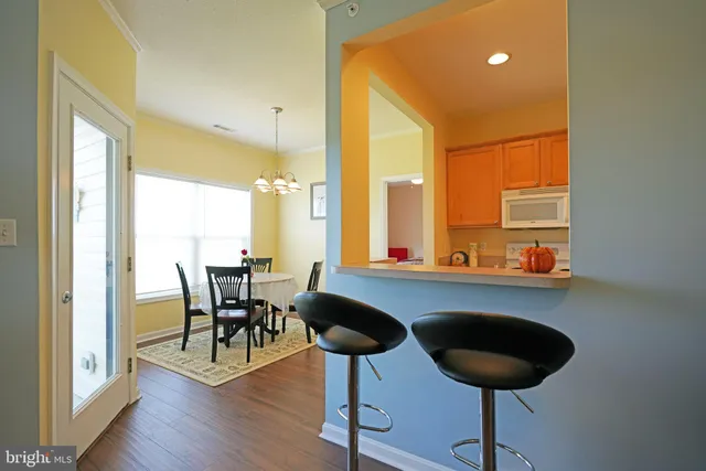 a dining room with furniture and wooden floor