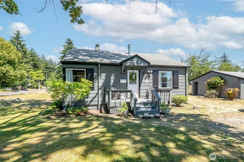 a front view of house with yard outdoor seating and barbeque oven