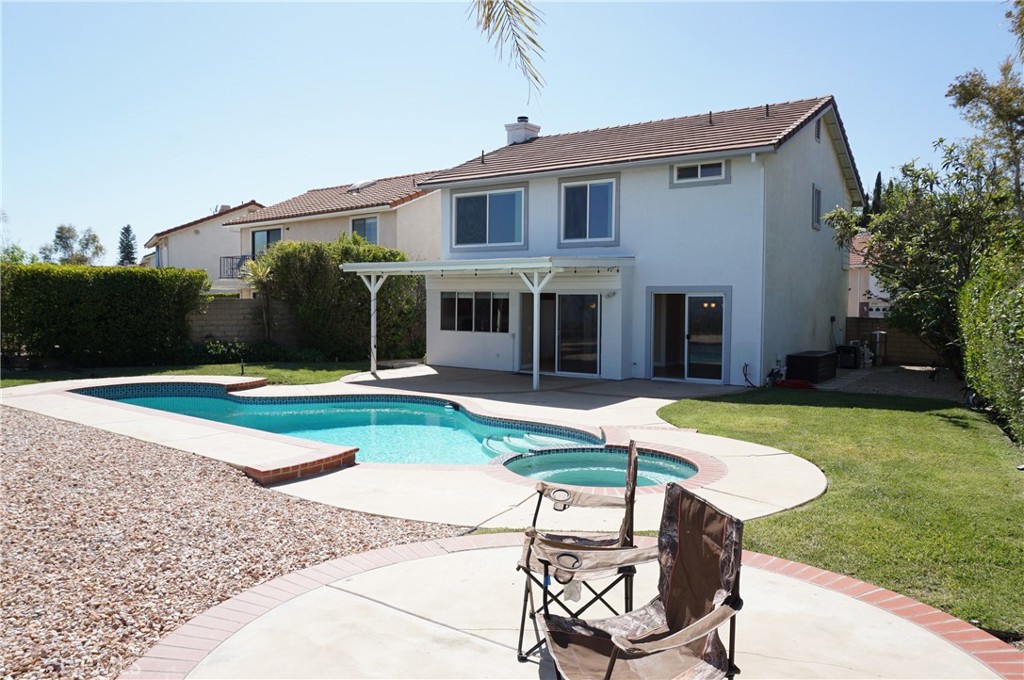 19584 Shadow Glen Circle Porter Ranch, CA 91326 - Photo 47 of 72 a view of a house with swimming pool and a yard