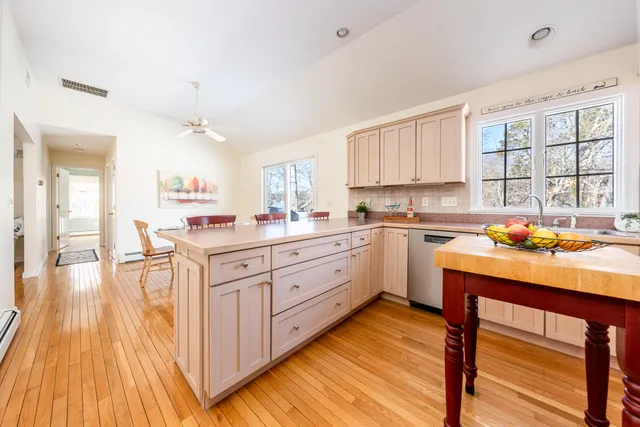 a kitchen with a sink window and cabinets