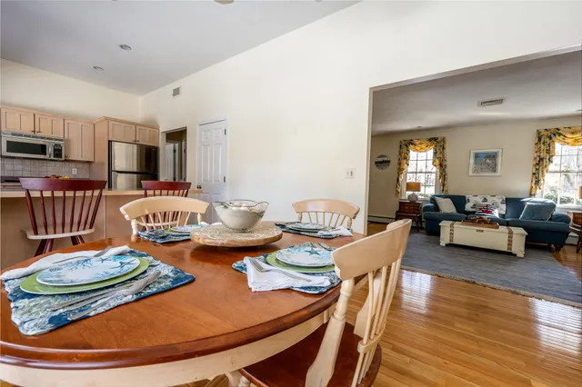 a living room with furniture and a dining table