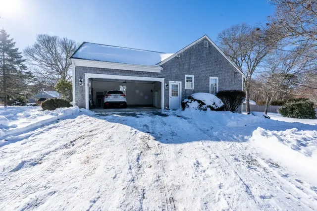 a view of a house with a yard covered with snow in front of house