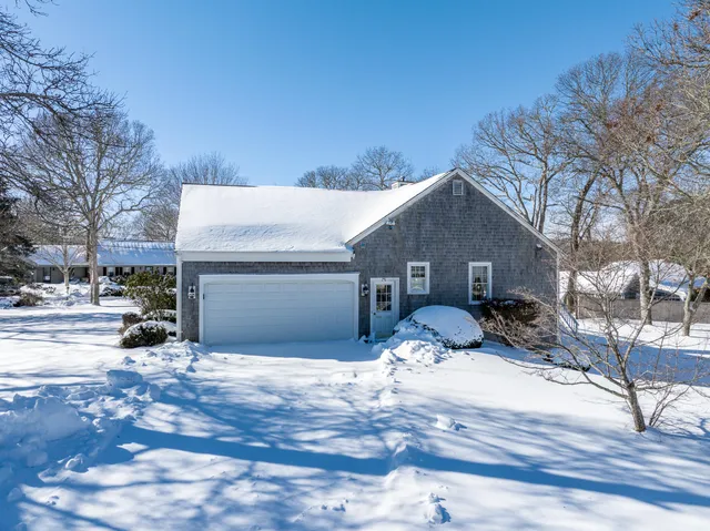 a view of a house with a snow in the background