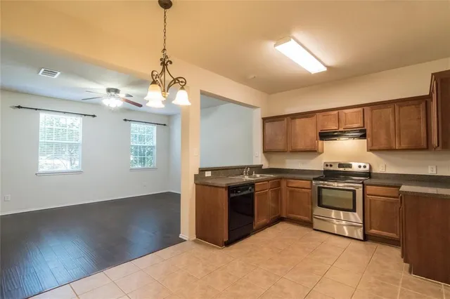 a kitchen with stainless steel appliances granite countertop a stove and a sink