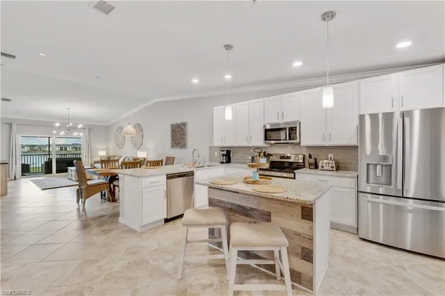 a kitchen with a refrigerator and a stove top oven