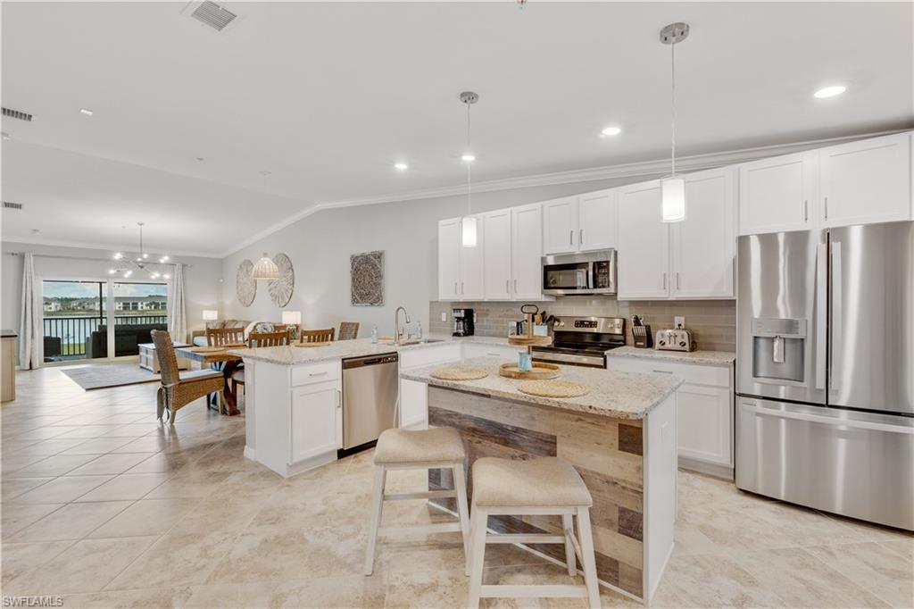43041 Greenway Boulevard, Unit 921 Babcock Ranch, FL 33982 - Photo 2 of 15 a kitchen with a refrigerator and a stove top oven
